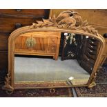 A giltwood overmantel mirror with carved bird and leaf decoration.