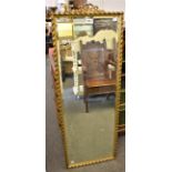 A bevelled glass mirror in gilt frame (120.2cm x 40.2cm)