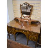 An Edwardian dressing table with shield shaped mirror.