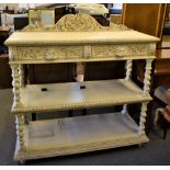 A three tiered buffet, two drawers with carved lions head handles