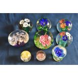 A collection of various flower paperweights plus others (9)