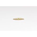A Victorian 9ct gold, peridot and seed pearl brooch elliptical with central oval cut peridot and