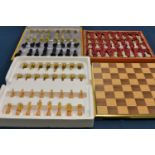 An oak and gold plated chess set plus a set of onyx chess pieces and a set of snadstone chess