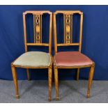 A pair of Edwardian satinwood bedroom chairs the angular, strung backs with pierced central