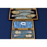 Two cased pairs of silver plated heavily embossed spoons Old English pattern, probably late