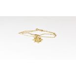 A Victorian 9ct gold and seed pearl snowflake pendant on a Victorian 9ct gold trace chain.