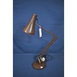 A vintage dark brown anglepoise desk lamp.