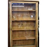 A glaze fronted display case with five shelves over double doors. 33in x 73in