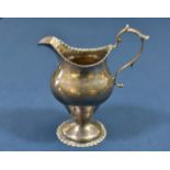 A George III silver pedestal cream jug maker's mark indistinct, London, 1779, punched bead border,