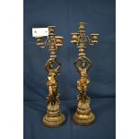 A pair of parcel gilt and bronze patinated spelter four light figural candelabra (2)