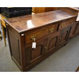 A mid-18th century cross banded oak dresser base of small proportions