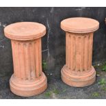 A pair of terracotta style composite stone garden column pedestals. (2)