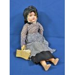 A 1920's German bisque headed doll in Guernsey dress.