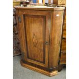 A George III inlaid oak corner cupboard with mahogany crossbanded panelled door.