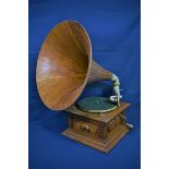 An antique HMV horn gramophone Junior Monarch, Reg No. 555515, oak body and large laminated oak