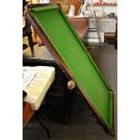 A table top slate bed billiards table together with cues, balls and scoring board (qty)