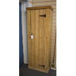 A rustic pine panelled hall/storage cupboard with four shelves.