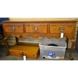A Georgian style dresser base with three frieze drawers over a shaped apron, on cabriole fore legs.
