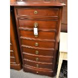 A French cherrywood tall bowfront chest of seven drawers