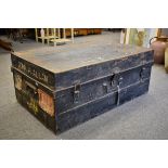 A vintage military style tin travel/storage chest with original travel stickers, 36in. (91.4cm.).