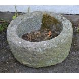 A weathered granite circular trough 21in diameter.