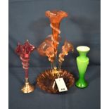 A Victorian cranberry glass epergne the four flutes with wavy rims and clear spiral pinchwork