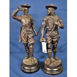 A pair of 19th century French spelter figures of Musketeers both standing wielding swords, the