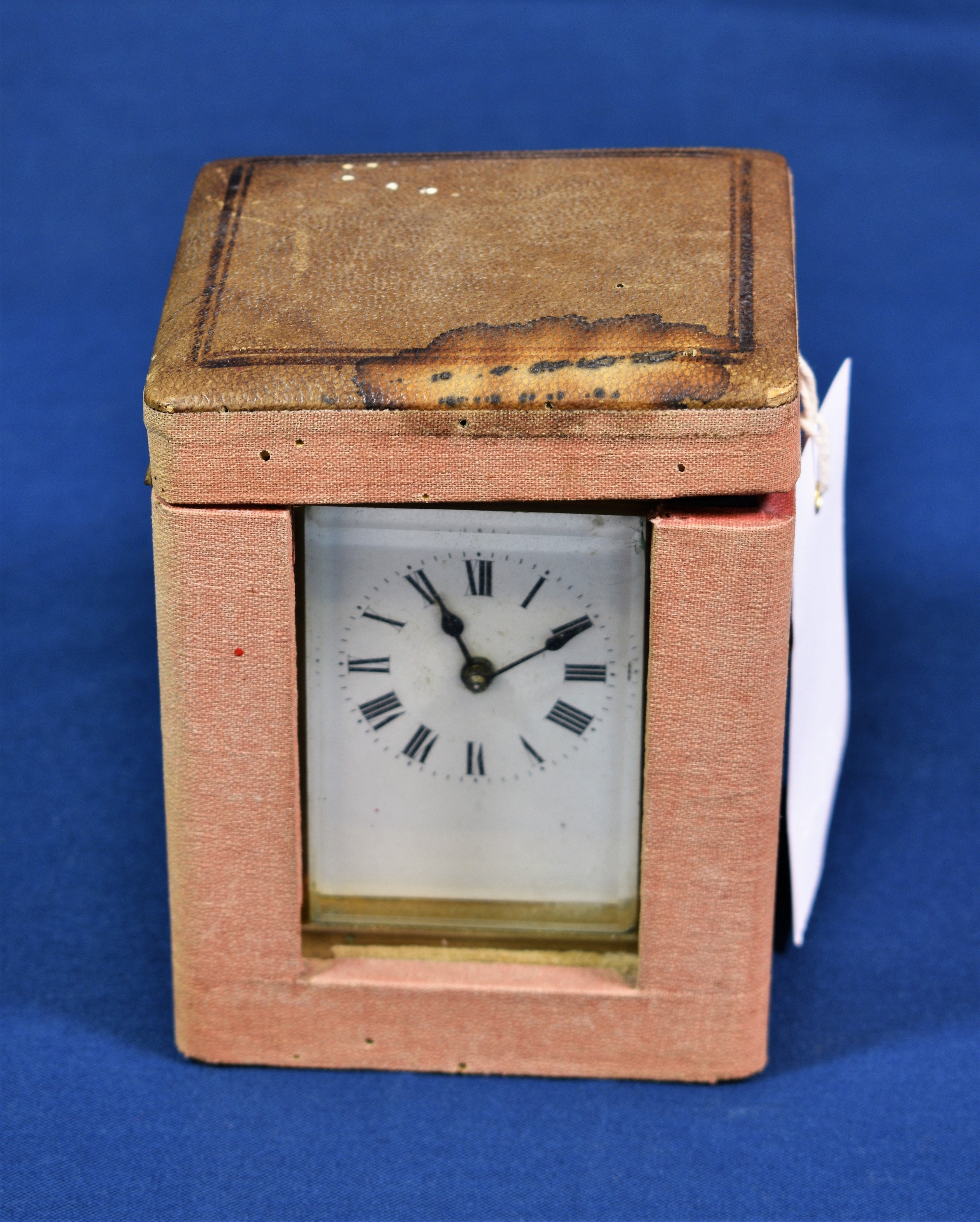 A French brass carriage timepiece with corniche case, white enamel Roman dial, single train