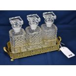 A gilt and silver plated three bottle tantalus
