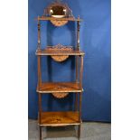 A Victorian walnut and marquetry four tier whatnot with mirrored fretwork top