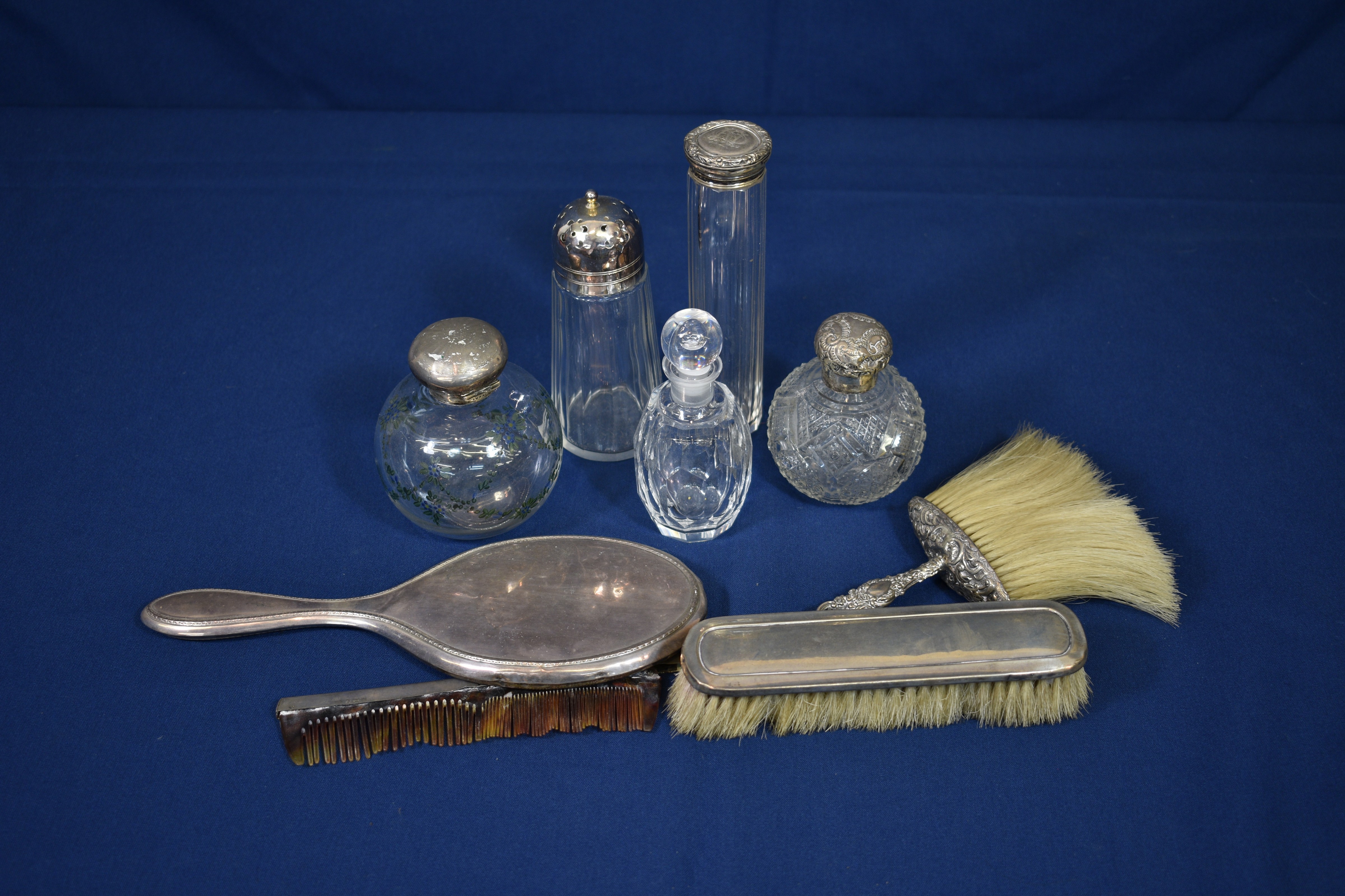 A Victorian silver clothes brush together with six other silver mounted dressing table items, some