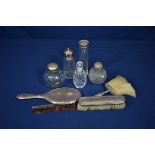 A Victorian silver clothes brush together with six other silver mounted dressing table items, some