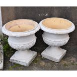 A pair of weathered contemporary garden urns