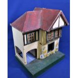 A vintage Triang dolls house No. 60, made circa 1937 and featuring metal framed windows, gabled roof