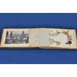 An olivewood bound book of pressed flowers, titled 'Flowers of the Holy Land', with photographs,