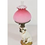 A Staffordshire pottery Bull Terrier dog converted to oil lamp pink milk glass shade (restored)