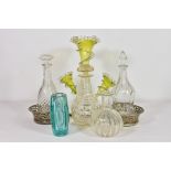 An antique green and clear glass epergne the three flutes with wavy rims and clear glass spiral