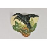 A Royal Doulton wall pocket, raven amongst oak leaves.