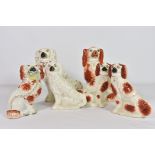 A collection of six ceramic Staffordshire spaniels, one with flower basket (6)