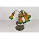 A Tiffany style five light table lamp with orange and green flower shades.