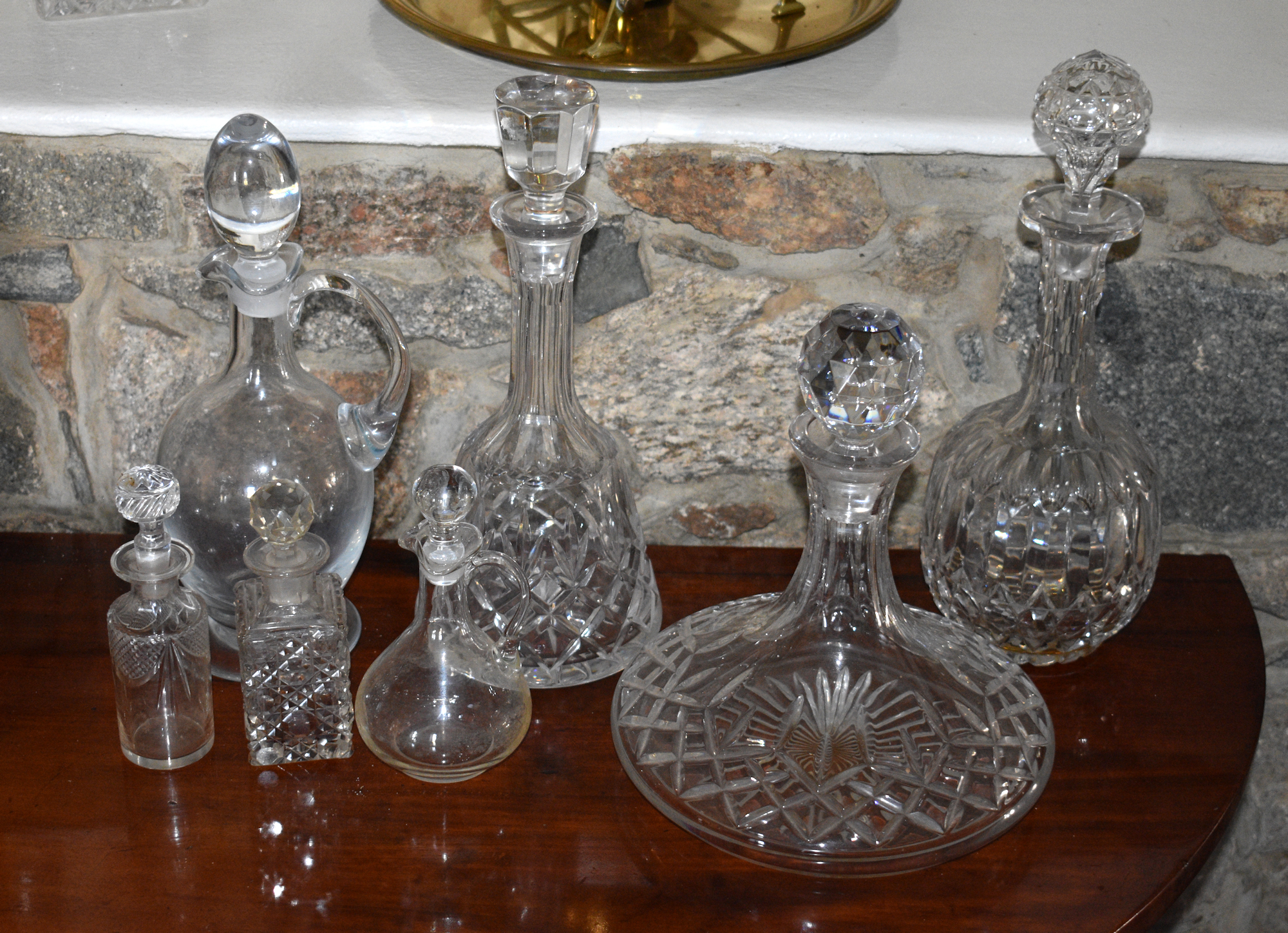 A Victorian cut glass globe and shaft decanter, together with a blown glass claret jug; a cut