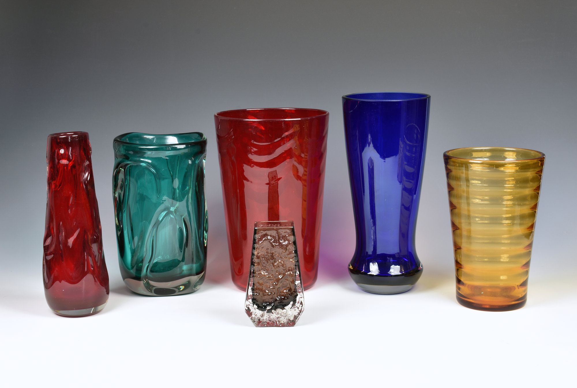 A collection of Whitefriars glass vases, to include a cinnamon coffin vase by Geoffrey Baxter, 5¼