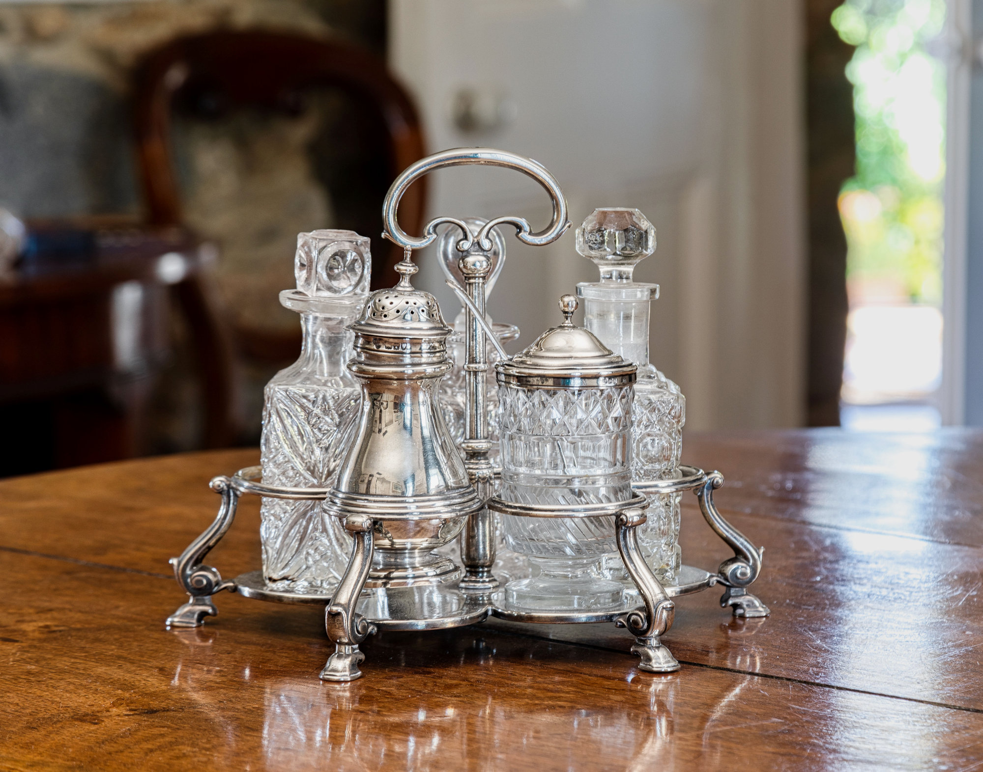 A George II silver five bottle cruet stand, Augustine Courtauld I, London, 1735, of flower shaped