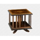 An Edwardian mahogany table-top, square revolving bookcase the veneered top with stained and penwork