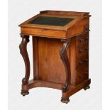 A mid Victorian straight grain walnut veneered Davenport the top with a short three quarter gallery,