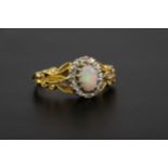 A Victorian style 18ct gold, opal and diamond cluster ring London 1976, the oval opal within a