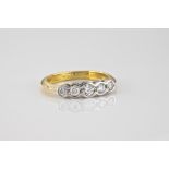 An 18ct yellow and white gold diamond five stone ring the five graduated brilliant cut diamonds in