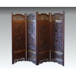A late 19th century Chinese carved hardwood four fold screen the shaped tops with scroll carved ears