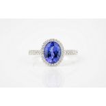 An 18ct white gold, Tanzanite and diamond cluster ring the 2.01ct oval cut Tanzanite in a halo