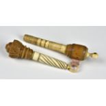 Two 19th century turned bone and Coquilla nut needle cases one having an integrated tape measure,